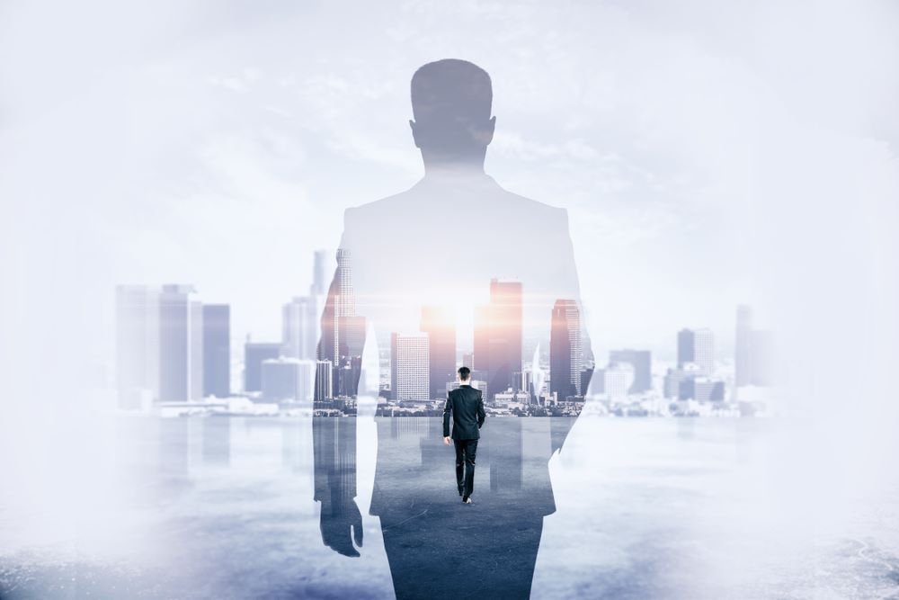 Back view of young businessman walking on abstract city background. Success and development concept. Double exposure